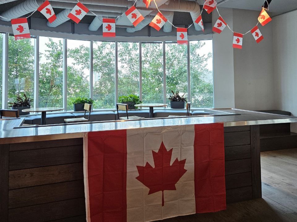 Room decorated with Canadian flags and maple leaf banners.