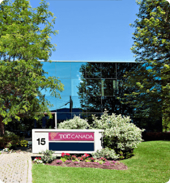 The exterior of a modern office building with a TCC Canada sign