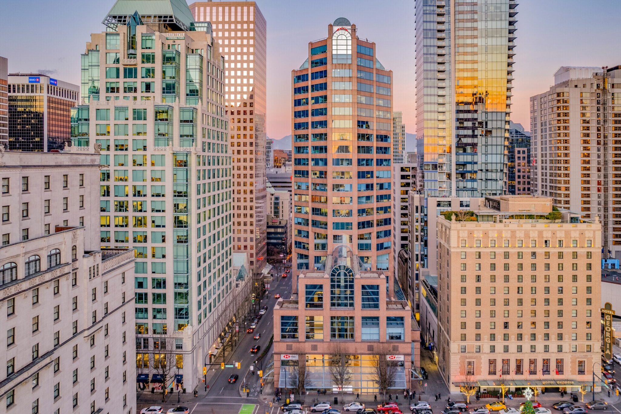 Aerial view of a bustling downtown workspace in Vancouver, featuring RBC Place where  TCC Canada's The City Centre is located. Streets are filled with cars.