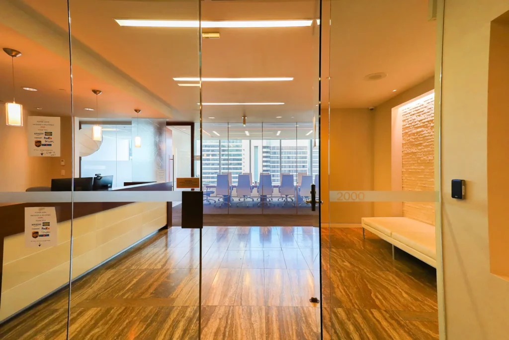 A view through glass doors into The City Centre's modern office reception area.