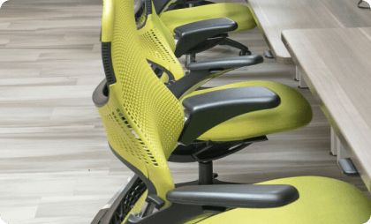 Modern office with a desk, computer, and yellow wall
