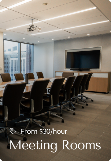 Professional meeting room with a long table, leather chairs, and a mounted screen, available from $30/hour.